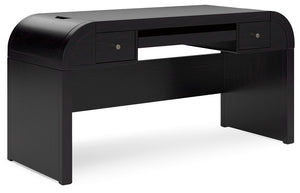Inspired by art deco design, this softly shaped home office desk makes a lasting impression in a simply stunning way. Its magnificent curved silhouette is enhanced by a rich layered black finish on the textured wood grain surface. Complete with ample stor