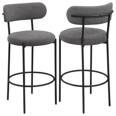 Refresh your kitchen island or elevated bar table with a set of two modern barstools. Each features foam cushions and contemporary boucle upholstery in a neutral hue. Black finish metal framing provides excellent support and durability, while slim legs an