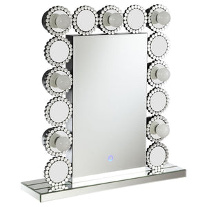 Rest this contemporary table mirror along a dresser or vanity surface for a playful, elegant aesthetic. Surrounded by seven LED bulbs that provide a soft, bright glow for perfecting your glow up, this table mirror offers a dramatic statement piece for bed