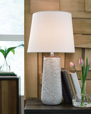  this table lamp provides maximum interest and exceptional versatility with its heavily textured surface. Whether resting on your nightstand or set on a side table