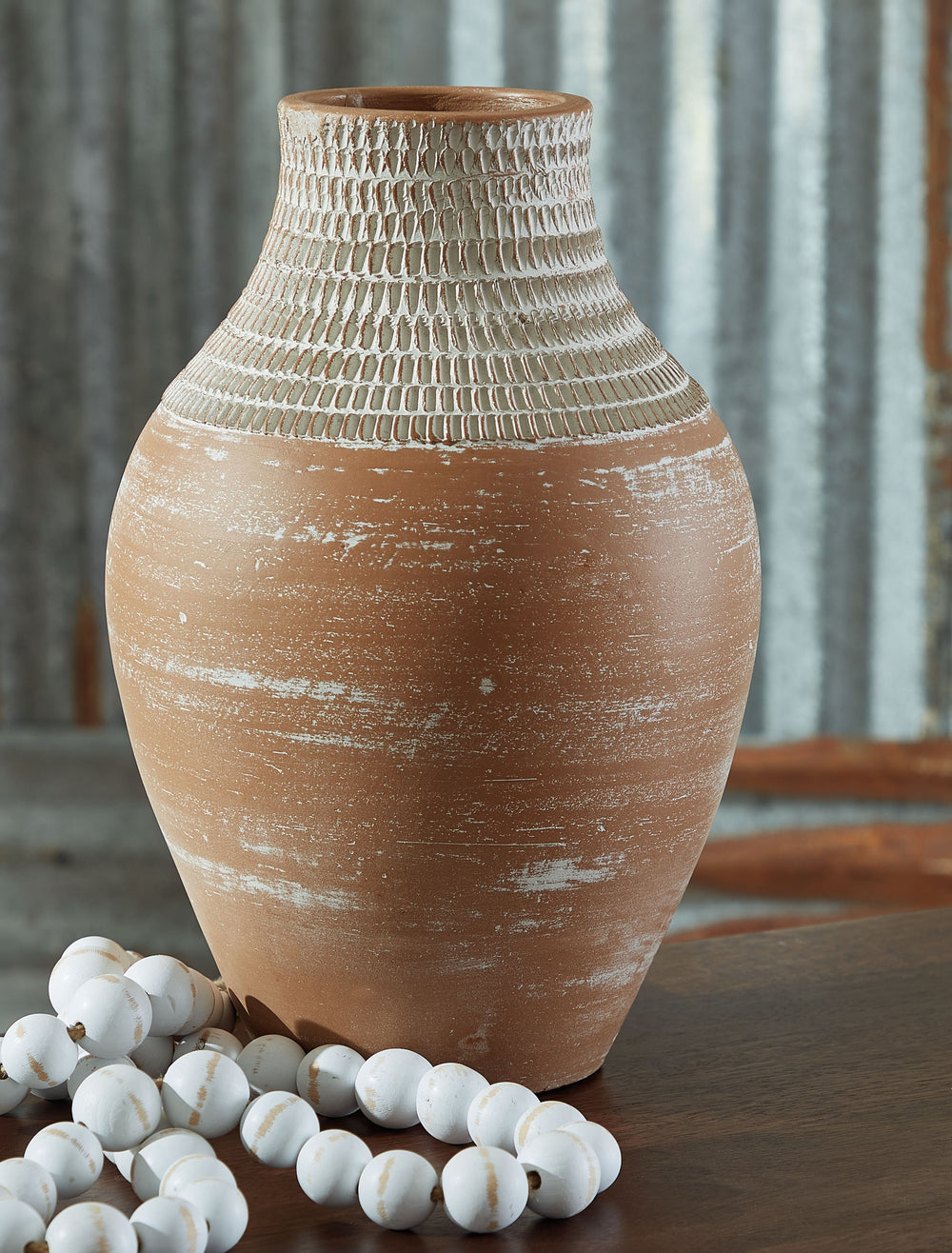 Casual, earthy design comes to life with this terra cotta vase. A distressed white patina is the perfect finish for this piece, giving it an understated presence to stand alone or in pairs on a shelf or display space.<br/><br/><b>Product Features</b><ul><