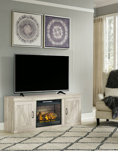 Express your modern farmhouse style with this TV stand with fireplace. Its wispy white finish over replicated oak grain is a delightful change from the ordinary. Clean-lined, classic styling with barn door inspiration provides a country-chic aesthetic tha