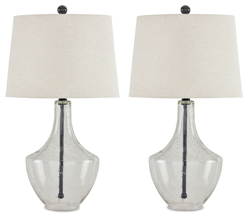 Simple yet elegant, this table lamp sets the scene for high style. Crafted of metal in a fashionable finish, this pair of lamps feature a straight post body enhanced in curvaceous seeded glass. Up top, a modified drum shade with beige fabric adds textural