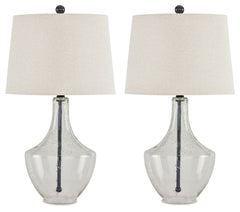 Simple yet elegant, this table lamp sets the scene for high style. Crafted of metal in a fashionable finish, this pair of lamps feature a straight post body enhanced in curvaceous seeded glass. Up top, a modified drum shade with beige fabric adds textural