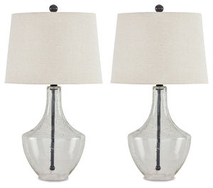 Simple yet elegant, this table lamp sets the scene for high style. Crafted of metal in a fashionable finish, this pair of lamps feature a straight post body enhanced in curvaceous seeded glass. Up top, a modified drum shade with beige fabric adds textural