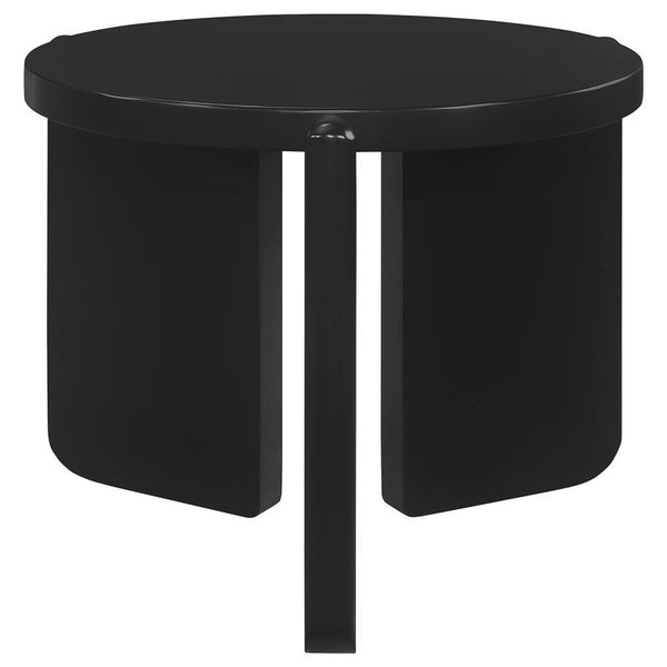 Nestled quietly by your sofa, this end table exudes a contemporary calm, its round shape a soft counterpoint to the angular lines of modern interiors. Solid wood bends and curves in a display of craftsmanship, presenting a substantial yet refined presence