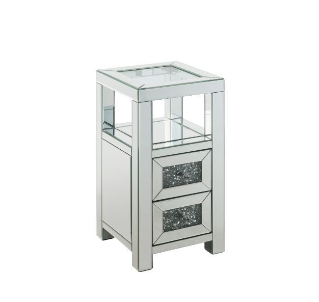 The modern glamour of the Noralie Accent Table will brighten your foyer or bedroom. This brilliant accent table features a mirrored finish and a clear tempered glass top, adding dimension, contrast, and shine to this functional piece. It has two drawers w