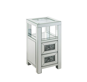 The modern glamour of the Noralie Accent Table will brighten your foyer or bedroom. This brilliant accent table features a mirrored finish and a clear tempered glass top, adding dimension, contrast, and shine to this functional piece. It has two drawers w