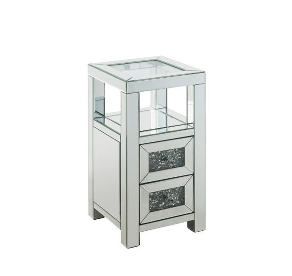 The modern glamour of the Noralie Accent Table will brighten your foyer or bedroom. This brilliant accent table features a mirrored finish and a clear tempered glass top, adding dimension, contrast, and shine to this functional piece. It has two drawers w