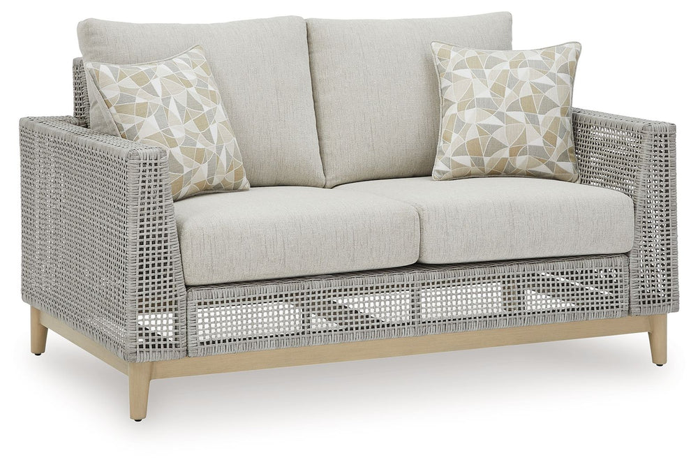 This loveseat invites your casual contemporary style outdoors. With its resin wicker in a chic neutral hue, it expertly marries refined design with durability. Breezy summer mornings and cold winter nights are made all the more comfortable with high-perfo