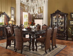 Irresistibly inviting, the Versailles collection displays the unrivaled beauty of the traditional dining. The dining table reflects highly decorative base with oversized scrolled feet, and the upholstered and tapestried chairs with the deep button tufted 
