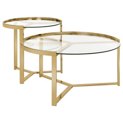 Embrace the elegance of this nesting coffee table set, where sleek round clear tempered glass tops rest gracefully atop a shimmering gold electroplated metal base. The modern, refined design captures a perfect balance of beauty and function, creating an e
