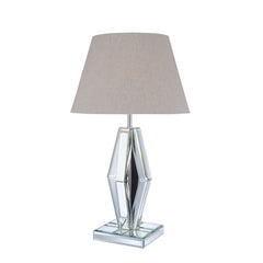 Create a luxurious space with this stunning faceted diamond crystal table lamp. This Britt table lamp is topped with a light brown fabric barrel shade and mirrored base. Featuring in LED light bulb and rocker switch on power cable, the clear finish expose