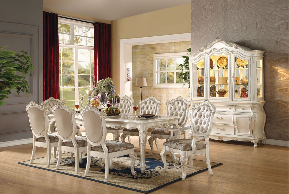 Designed exclusively for ACME, the Chantelle collection is filled with romantic wonder. This collection features a beautiful floral carved leg table available in two different sizes. Complemented by French rococo tufted rose gold upholstery chairs and mat