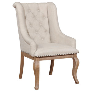  the chair boasts diamond button tufting across its back