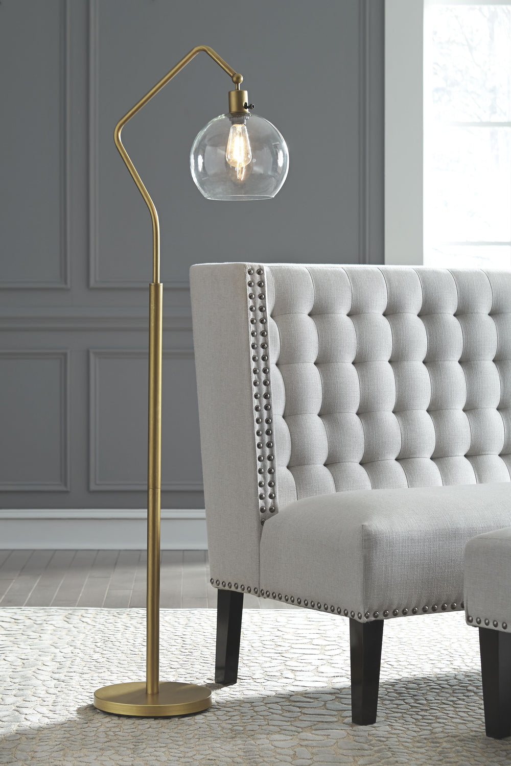 See light through a modern-day lens with this floor lamp. Antiqued brass-tone finish has the warm, eye-catching aesthetic you love. Glass shade hangs from a beautiful angular arm to illuminate your home.<br><br><b>Additional Dimensions</b><br><ul><li>Shad