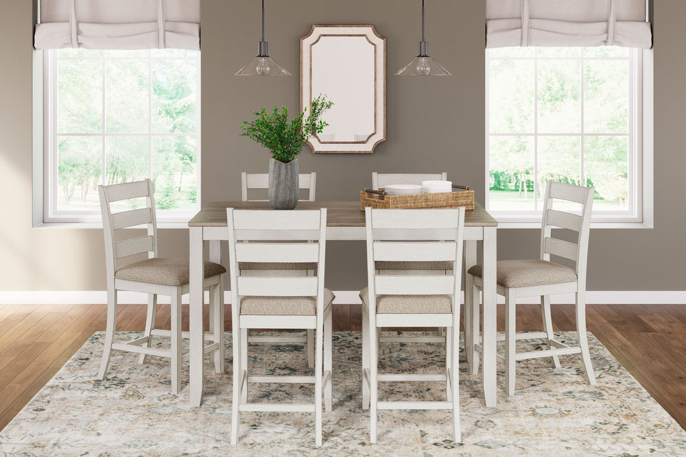 Set the scene for coastal chic or modern farmhouse living with this counter height dining set. The clean-lined, simply striking table doubles the charm with a brown plank effect top, paired with a grayish white base with a rub through effect for timeworn 