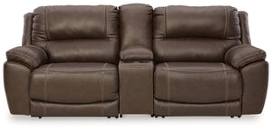 Load up on comfort in a cool, clean-lined and contemporary way with this power reclining loveseat with console in chocolate brown. Rest assured, the expertly matched leather and faux leather upholstery is enriched with a pebble grain effect for authentic 