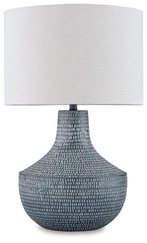 Enhance your decor with a touch of captivating texture. This table lamp features a beautifully crafted body made of hammered metal with an antiqued finish. Topped with a crisp off-white fabric shade, it illuminates a casual vibe with soft, diffused light.