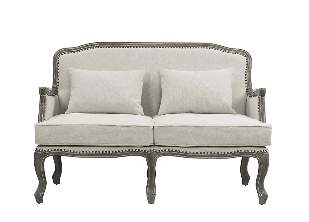 Finely crafted with superb carved details and a lovely natural finish, the Tania sofa flaunts a French cabriole silhouette that perches on graceful cabriole legs and showcases its antique-inspired profile. The nailhead trim accents give this piece a moder
