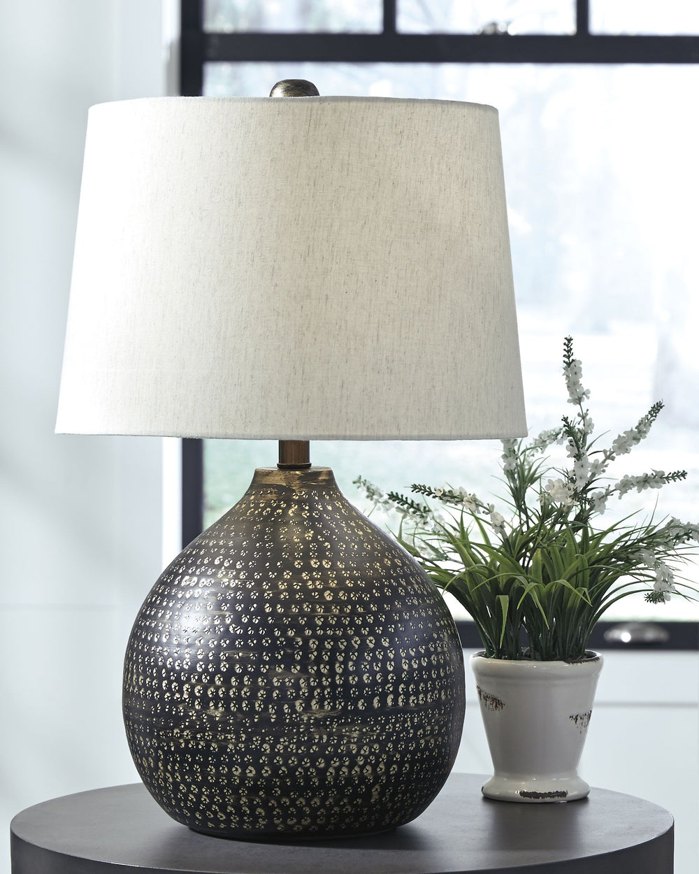 Infuse your home with the casual vibe of this table lamp. Black finish is elevated with a goldtone circular pattern. Its slightly urban industrial design brings balance and brightness to your room with double the style.<br><br><b>Additional Dimensions</b>