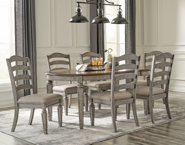 This dining room group adds understated beauty to any dining space with its traditional cottage design. Its outstanding two-tone finish features an antiqued gray body with a rich deep walnut brown top. This ample round table includes one extension leaf to