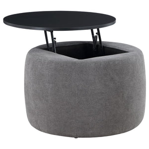 Indulge in the seamless blend of functionality and style with this chic round ottoman. Draped in sumptuously soft grey chenille, it invites relaxation while concealing a spacious storage compartment beneath its sleek black lift-top. Its subtle charm is el