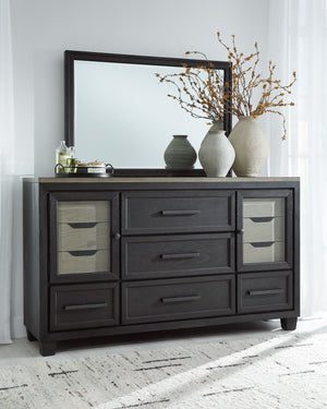 This dresser and mirror set is casual contemporary style simply done right. Its two-tone color scheme features a rich brushed black main color accented with a beautiful dusty grayish brown wood tone. With 11 soft-close drawers (three located neatly behind