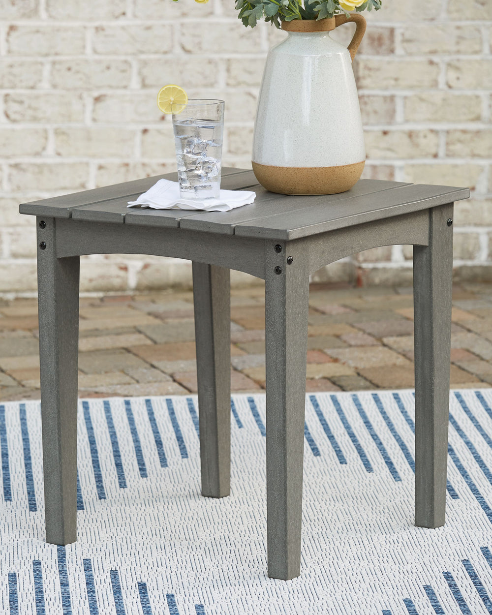 Itâ€™s the dawn of a new day for gray. Embrace the style trend with this outdoor end table. Crafted of HDPE material that combines the exceptional durability and weather resistance you need with the â€œwood lookâ€ you love, the rectangular table takes al