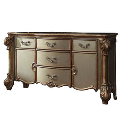 Create an elegant, traditional design in your bedroom with the gold patina bone Vendome dresser. This hand-crafted piece inspired from the luxurious deigns of the past, this five-drawer, two-door dresser features elaborate wood carving details, traditiona