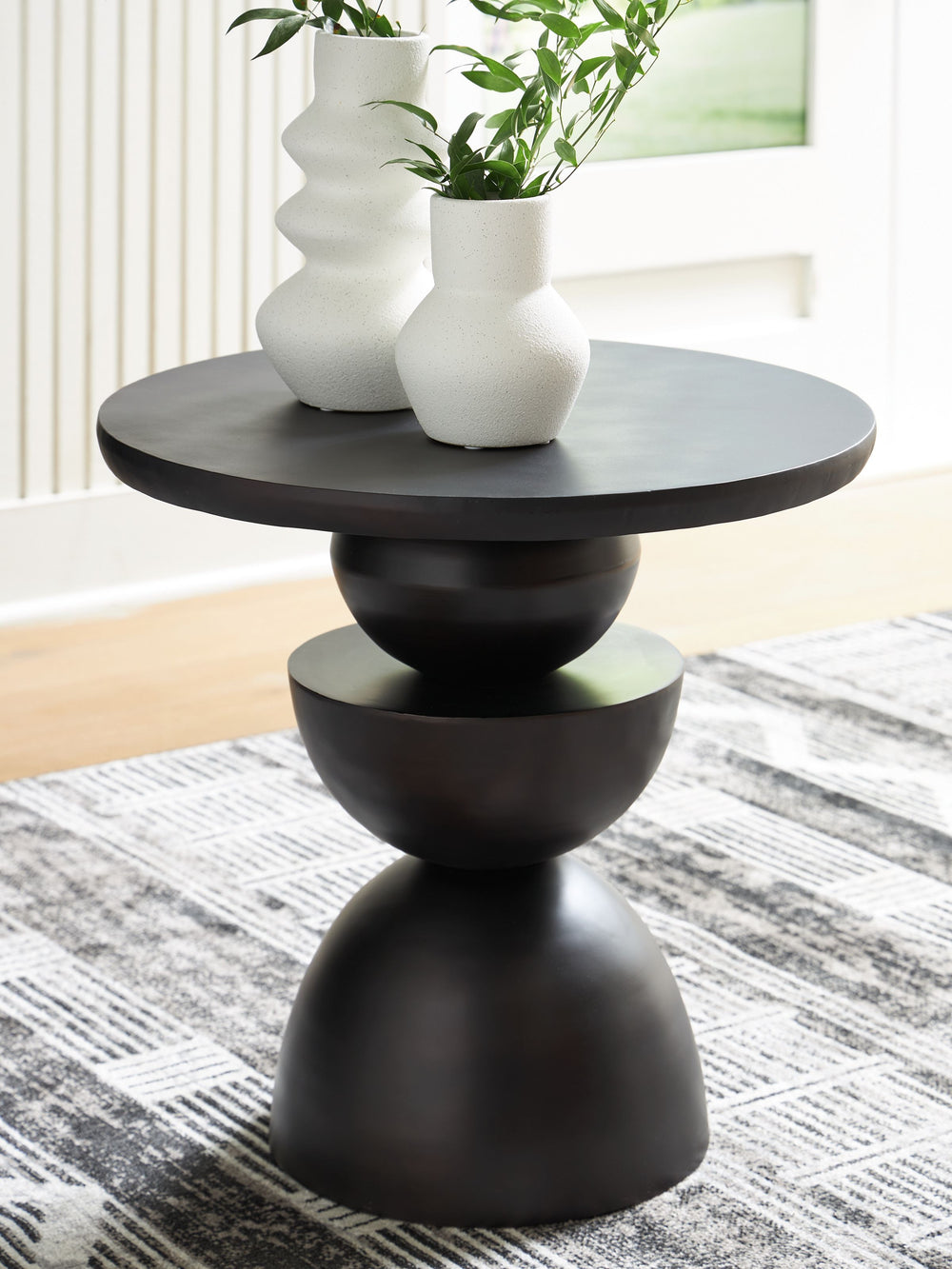 Go bold in your home with this accent table. Geometric forms come together to create the dynamically layered base, with a bronze-tone finish giving it an ultra-cool edge. An art piece when standing on its own, this table also acts as a striking pedestal f