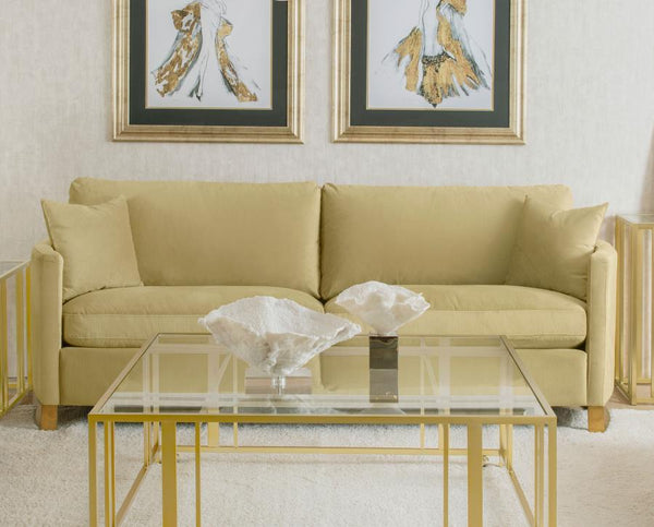  complemented by curved arms and gold stainless steel legs. Smooth upholstery and lustrous details blend simplicity with timeless splendor