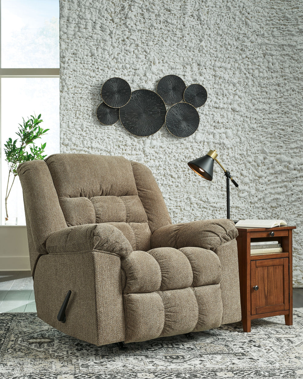 Prioritize comfort while still making a versatile style statement. Complementing a variety of color schemes, this rocker recliner-'s supremely plush seating lines you up for hours of leisure. Its one-pull reclining motion places you in optimal TV watching