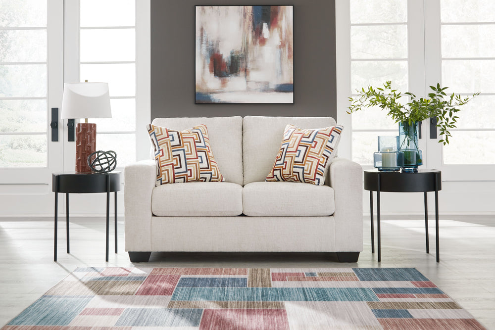 Looking to make a simply chic statement with color? Liven up your living room with this loveseat. Its trend-right light neutral upholstery is a perfect blank canvas for adding pops of color. Bold and eclectic accent pillows complete the look. Pairing posh