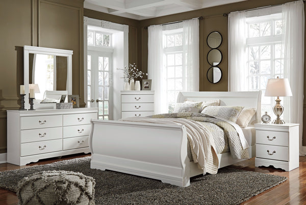 Louis Philippe styling. Replicated white paint. Shapely top mouldings on the case pieces. Antiqued pewter color metal hardware complementing the Louis style. Side roller glide drawer system for smooth operating drawers. Curvaceous footboard panel capped w