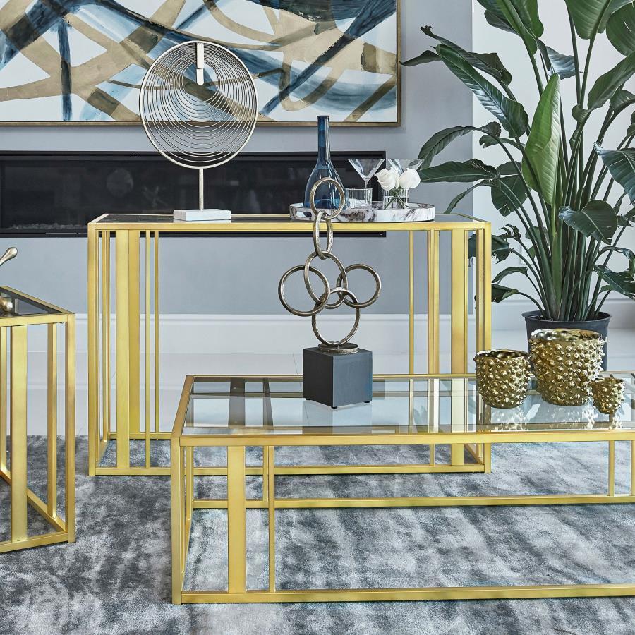 This modern rectangular console table features a clear tempered glass top paired with a geometric base crafted from heavy-gauge metal with a sleek electroplated finish. The open design creates a contemporary aesthetic, offering both elegance and durabilit