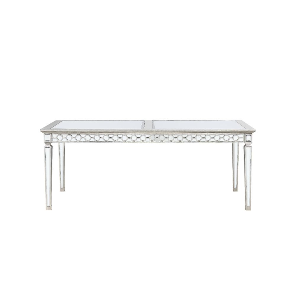 Let the Varian dining collection reflect your brilliant style! This chic set features a rectangular table accented with a beveled mirror trim in a geometric design. The matching chairs are upholstered in a lustrous blue fabric and supported by elegantly t
