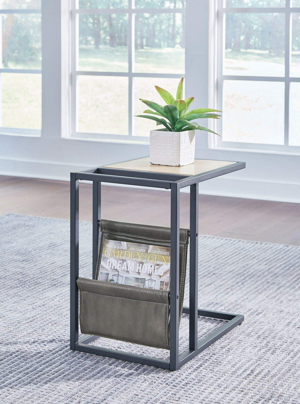 Casual contemporary design with a clean silhouette. That-'s the beauty of this chairside end table. Quality crafted with elm veneer, its tabletop is finished in a light natural wood tone that lends a fresh, organic look. Cool metal C-frame in a matte blac