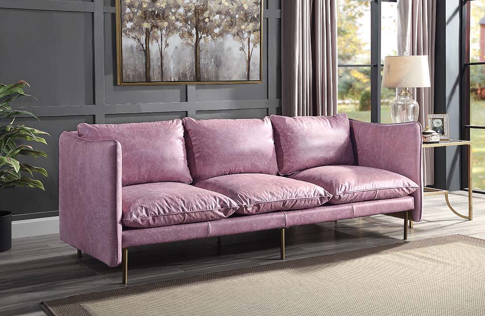 The Metis sofa is upholstered in buttery SOFT top grain leather in a Wisteria color that adds a touch of effortless romance to any room. The luxurious sofa is equipped with ultra-plush cushions and backrests. The metal brass legs add a hint of modern indu