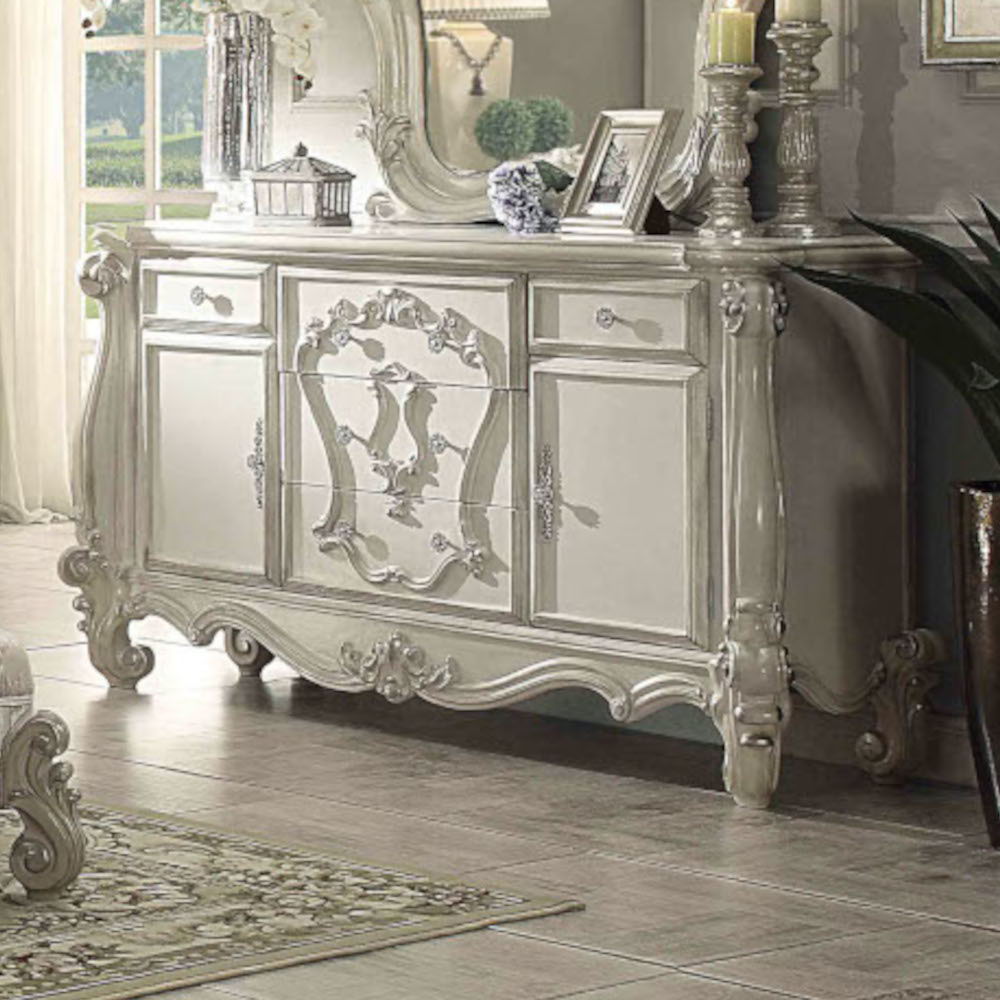 The Versailles dresser is the perfect accent to create the style of royalty your bedroom has been needing. This dresser crafted in wood with bone white finish was inspired by old European design with brown copper metal hardware and intricate wood carvings