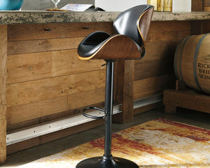  this upholstered swivel bar stool is sure to bring an elevated look to your living space. Wrapped in a brown faux leather upholstery