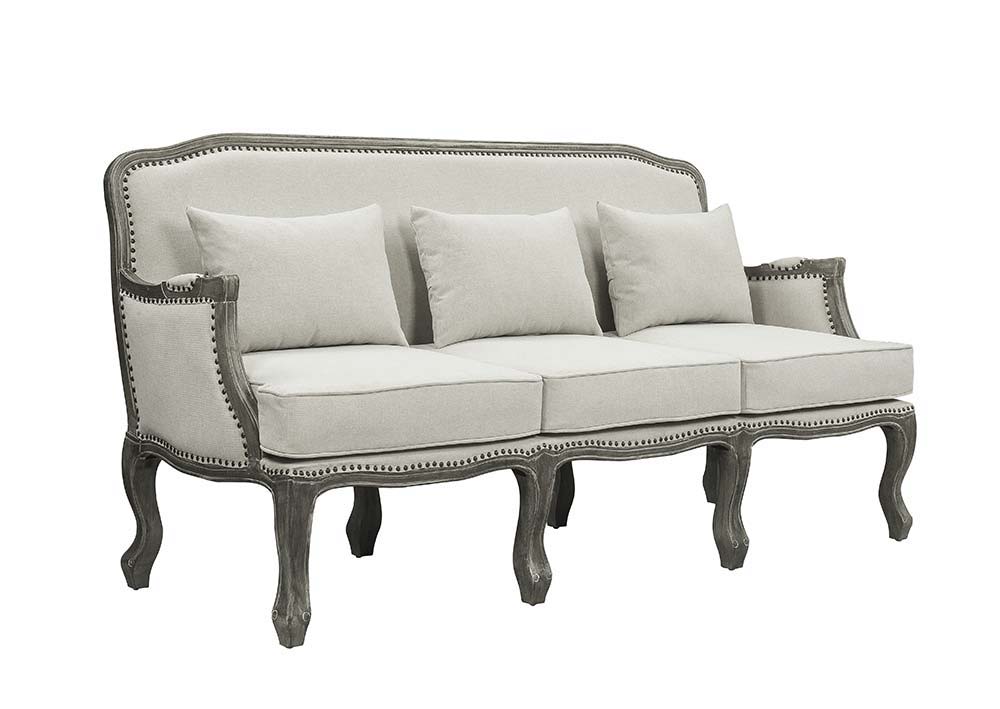 Finely crafted with superb carved details and a lovely natural finish, the Tania sofa flaunts a French cabriole silhouette that perches on graceful cabriole legs and showcases its antique-inspired profile. The nailhead trim accents give this piece a moder