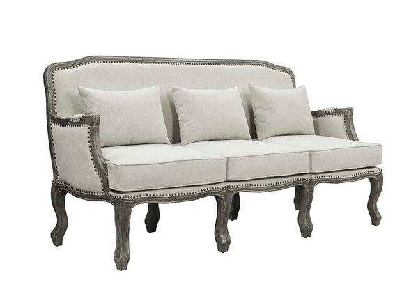 Finely crafted with superb carved details and a lovely natural finish, the Tania sofa flaunts a French cabriole silhouette that perches on graceful cabriole legs and showcases its antique-inspired profile. The nailhead trim accents give this piece a moder