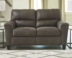  you can take comfort in this loveseat. Wrapped in a fabulous faux leather with a weathered hue and hint of pebbly texture to resemble the real deal
