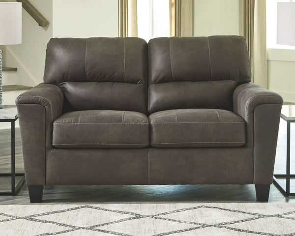  you can take comfort in this loveseat. Wrapped in a fabulous faux leather with a weathered hue and hint of pebbly texture to resemble the real deal