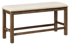 This counter height upholstered bench might be simple at first sight, but a closer look reveals beauty in the details. With a distressed nutmeg finish, antiqued nailhead trim and textured polyester upholstery, it-'s beaming with charm. Cushioned seat ensu