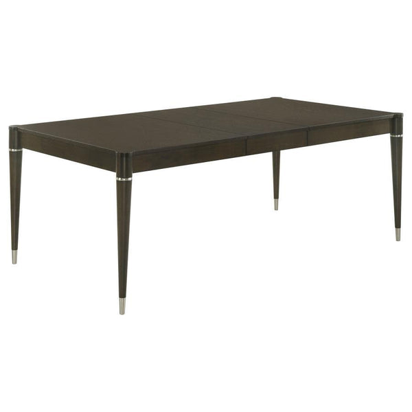 Enhance your dining experience with this contemporary dining table in a stunning ash brown finish. Crafted with a combination of engineered wood, Asian hardwood, and ash veneer, it delivers durability and timeless elegance. The table extends from 63 inche