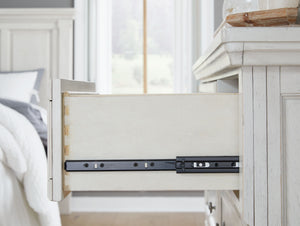  while the dark bronze-tone hardware adds an ornate