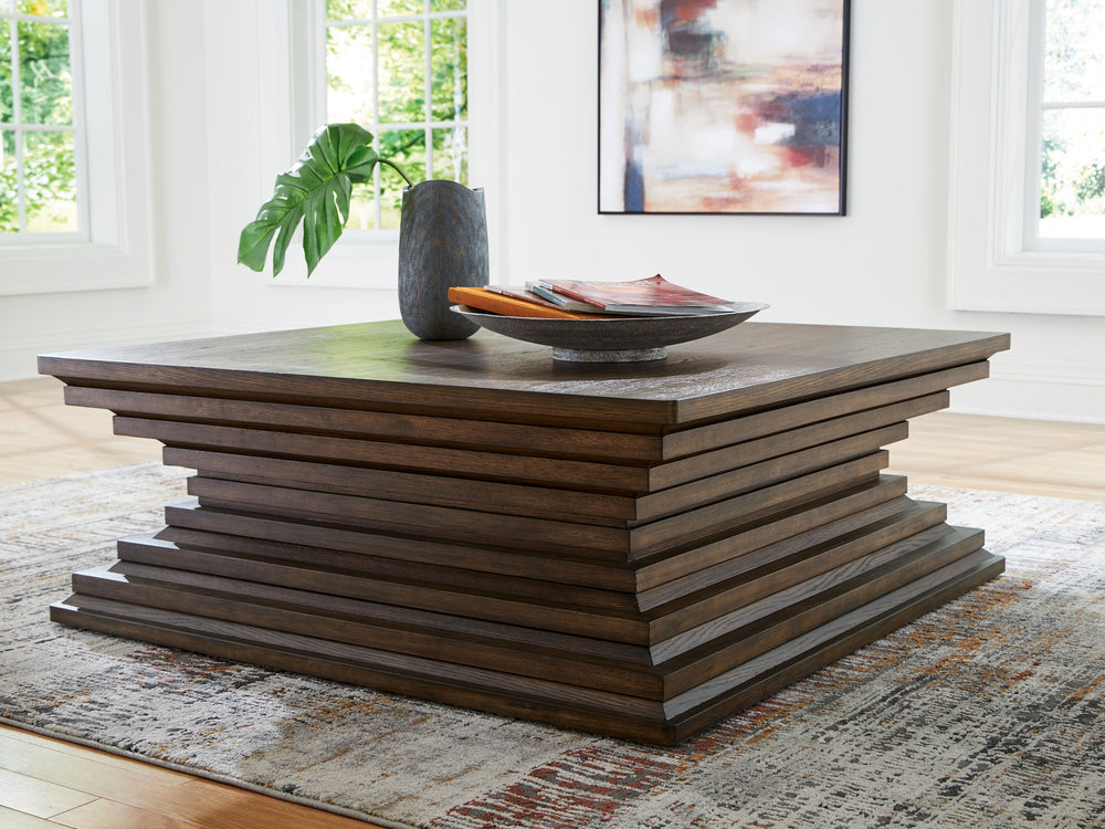 A statement-making table? Yes, please. The distinctive silhouette of this coffee table is sure to captivate lovers of contemporary design. Featuring head-turning architectural geometry and a rich, inviting warm brown finish, this piece is ready to take yo