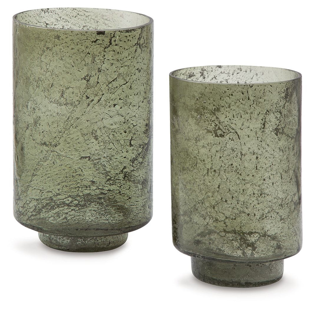Create an even cozier ambiance in your home with this candle holder set. Their green sanded glass makes the soft glow of electric or real candles all the more beautiful. Stunning when displayed as a duo or standing alone, these holders are a simple way to